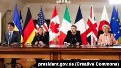 Canadian Prime Minister Justin Trudeau, Italian Prime Minister Giorgia Meloni, Ukrainian President Volodymyr Zelenskiy, and European Commission President Ursula von der Leyen join the virtual G7 leaders' meeting from Kyiv on February 24.