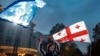 A Georgian man holds an EU flag during a celebratory rally after Georgia was granted official candidate status in Tbilisi on December 15. 