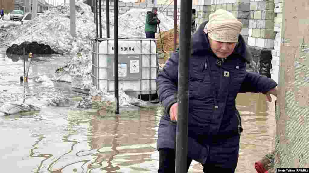 A woman struggles to make her way in Koyandy. Six protesters in the village were fined by the authorities for &quot;participating in an illegal rally.&quot;