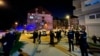 Police gather outside the Transparency International office after an attack on activists on March 18.