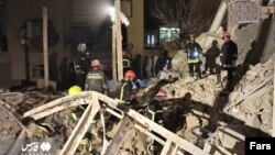 Rescue workers attend the site of an explosion in western Iran on March 12.