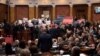Members of the Serbia Against Violence coalition blew whistles and waved banners reading "Election fraud" and "You stole the elections" in the Serbian National Assembly on February 6. 