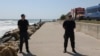 Members of the Inspectorate for Emergency Situations and the Internal Affairs Ministry stand guard near the cliff where an explosion occurred in Costinesti, Romania, on August 14.
