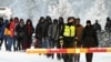 Finnish border guards escort would-be migrants at the border with Russia at Salla in northern Finland on November 23.