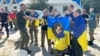 Ukrainian soldiers who were part of the prisoner exchange pose for a photo on August 24. Russia and Ukraine exchanged 115 prisoners each. 
