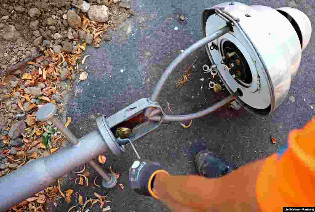 A worker dismantles a gas street lamp in Berlin on August 10. The Kremlin appears to be using its gas-powered leverage to pressure Germany over its support for Ukraine. Flows of Russian gas through the Nord Stream 1 pipeline were cut to less than 20 percent of capacity in July, with Russia's Gazprom citing "equipment repairs" for the strangled gas flow. 