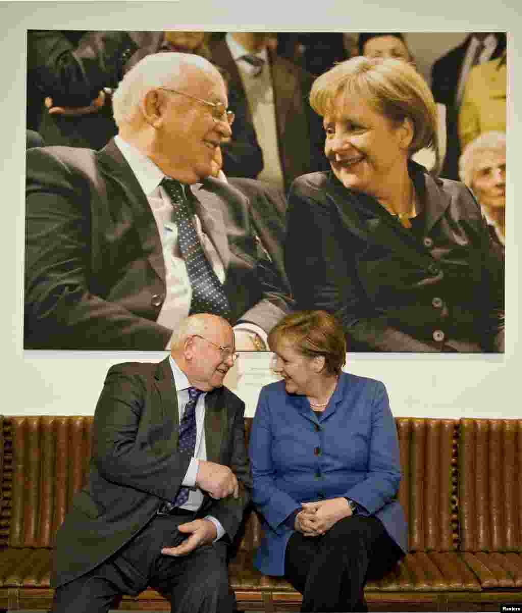 With German Chancellor Angela Merkel at an exhibition in Berlin on February 24, 2011, marking Gorbachev's 80th birthday.