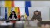 A screen grab of video showing Montenegrin Prime Minister Dritan Abazovic (left) and Ukrainian President Volodymyr Zelenskiy signing a joint declaration on Ukraine's Euro-Atlantic perspective on December 5. 