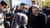 Uzbek President Shavkat Mirziyoev speaks with supporters at a polling station in Tashkent during the presidential election in October 2021.