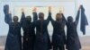 Female students remove their head scarves as a form of protest as thousands of Iranians have taken to the streets to demand more freedoms and women's rights. 