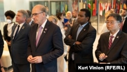 US congressional delegation at RFE/RL's headquarters in Prague in May 2022. Representatives Michael McCaul (left), Bill Keating, Joe Neguse, and Ted Lieu view a memorial to slain journalists. (file photo)