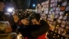 Mourners attend an outdoor vigil for the victims of Ukrainian passenger jet flight PS752 in Toronto, Canada, in January 2022.