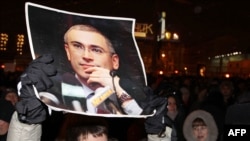 A demonstrator in Moscow holds a portrait of jailed tycoon Mikhail Khodorkovsky on December 31.