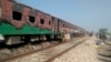 Pakistani officials examine a train damaged by a deadly fire in Punjab Province on October 31. 