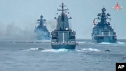 In this photo released by Russian Defense Ministry on July 21, Russian warships take part in naval drills in the Black Sea.