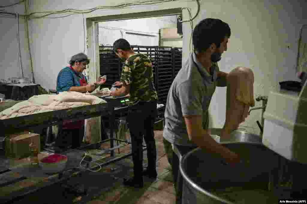 Ghevondian (left) works with colleagues to split the dough into portions before sliding it into an electric oven. The baker's 20-year-old son is currently fighting on the front lines of the battle for Nagorno-Karabakh. She told AFP: "If my son is there, how could I leave here? I don't ask for anything else. My house can be destroyed, but I want my son near me." 