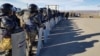 Riot police deployed to the village of Masanchi on February 8.