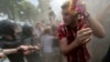 Russian police push a gay-rights activist away from the scene of a gay-pride event to prevent clashes with antigay protesters in St. Petersburg in June 2013.