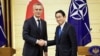 NATO Secretary-General Jens Stoltenberg (left) and Japanese Prime Minister Fumio Kishida shake hands after holding a joint media briefing on January 31 in Tokyo. 
