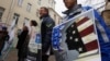 Protesters hold up signs outside the Moscow office of the election-monitoring NGO Golos accusing it of being a foreign agent in April 2013.