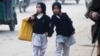 Two girls walk to school in Peshawar.