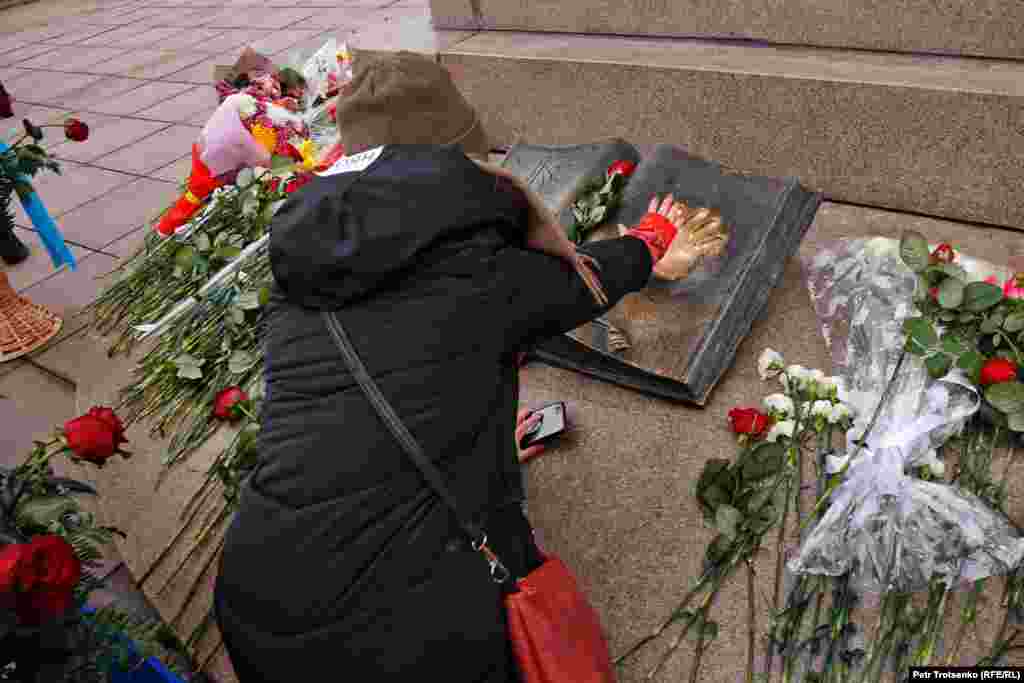 A young woman at Almaty's Independence Monument. 