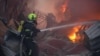 Firefighters work at the site of an office building hit by a Russian missile strike in Kyiv early on April 6.