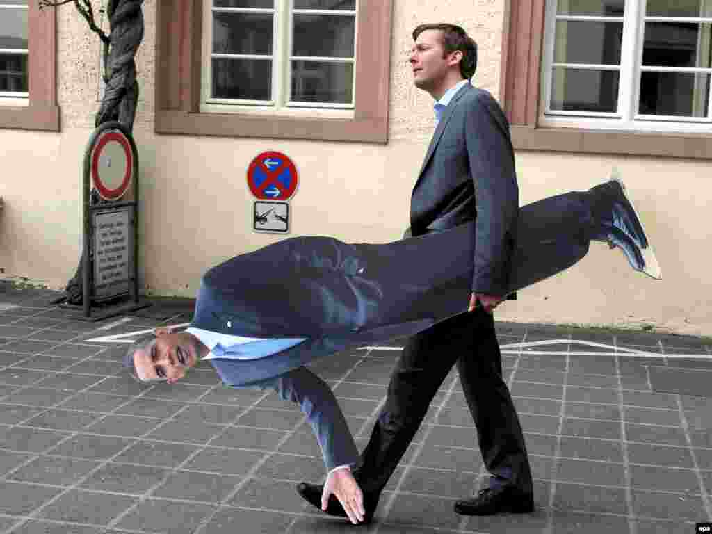 German TV host Clemens Bratzler holds a cardboard cutout of Obama in Baden-Baden for a segment of his show. - After the G20 meeting came NATO's 60th anniversary summit, where member states debated challenges ranging from the alliance's first-ever out-of-area mission in Afghanistan to the resurgence of Russia.
