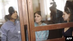 Members of Pussy Riot during a court hearing in Moscow on July 30: Nadezhda Tolokonnikova (left), Yekaterina Samutsevich (center), and Maria Alyokhina. They face up to seven years in prison.