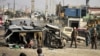 Afghan security officials inspect the scene of a suicide bomb attack that targeted a vehicle of the British Embassy in Kabul on November 27.