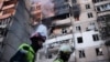 Firefighters work at a heavily damaged residential building following Russian drone and missile strikes in Kyiv on September 7.