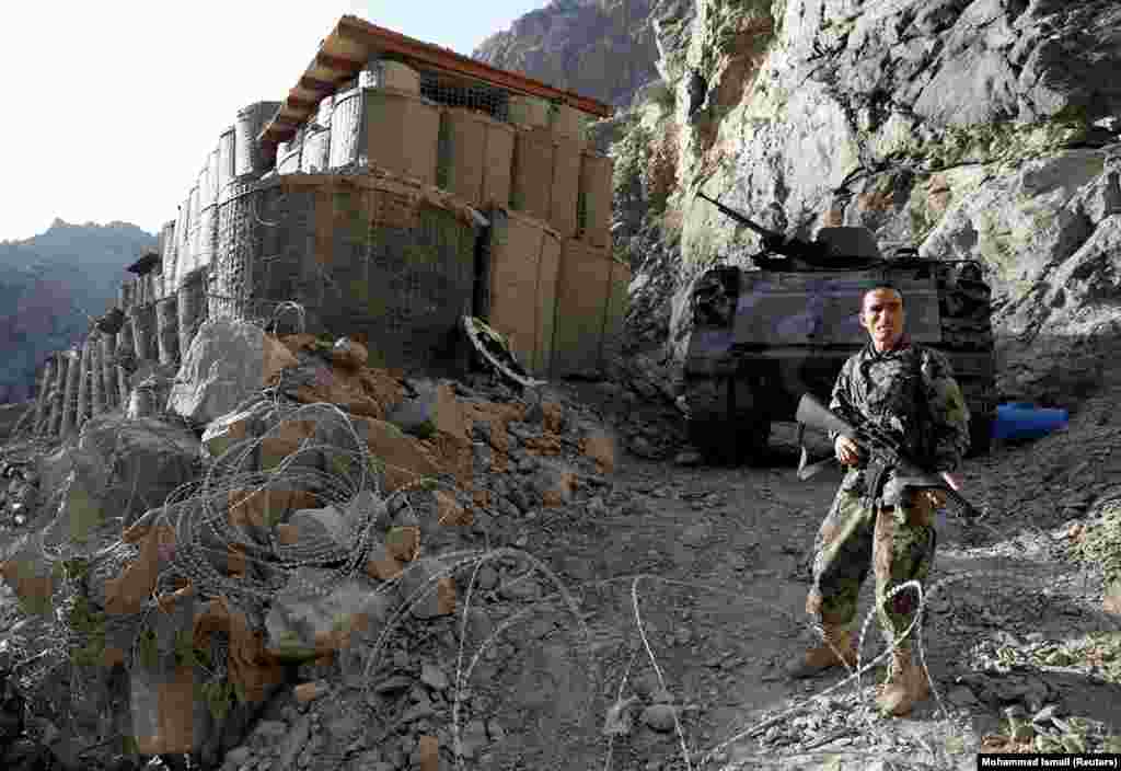 An Afghan National Army soldier stands guard at an isolated checkpoint on the highway between Jalalabad and Kabul on July 8. 