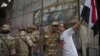 An Egyptian man welcomes an army soldier upon his deployment on a street leading to Cairo University on July 3. 