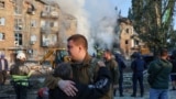 Survivors of the Russian attack left the rubble of their homes with few belongings, some carrying their pets.