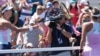 Marta Kostyuk of Ukraine (right) used a racquet touch instead of a handshake after losing to Victoria Azarenka of Belarus (left) at the U.S. Open in New York.