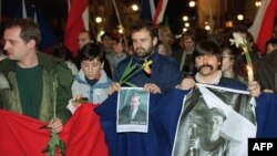 Czechoslovak students holding a picture of Vaclav Havel and poster reading "The Truth Will Win" march in support of Havel for president in December 1989 in Prague.