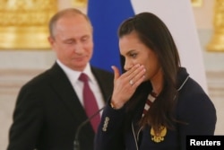 Pole vaulter Yelena Isinbayeva and Russian President Vladimir Putin during his send-off for the Russian Olympic team at the Kremlin in 2016. A day after calling homosexuality a "problem" in 2013, Isinbayeva said she had been misunderstood.