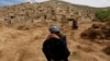 Afghan survivors mourn for their relatives at the site of a landslide at the Argo district in Badakhshan Province.