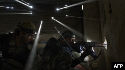 Two Syrian rebels take sniper positions in a heavily contested neighborhood of central Aleppo. Internecine strife has now been raging in the country for 3 1/2 years, killing an estimated 190,000 people. 