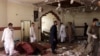  Members of a bomb-disposal unit survey the site after a blast at a mosque in Kuchlak, on the outskirts of Quetta, on August 16.