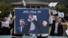 SOUTH KOREA -- 'Pro-peace' activists hold a placard showing South Korean President Moon Jae-in and North Korean leader Kim Jong Un, with a slogan reading: reading 'Peace New Start', during a demonstration outside the presidential Blue House in Seoul, Apri