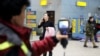 Kazakh personnel use a thermal scanner to detect travelers from China who may have symptoms possibly connected with the coronavirus at Almaty International Airport on January 21.