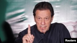 Imran Khan gestures as he speaks to the media at his residence in Lahore on May 18.