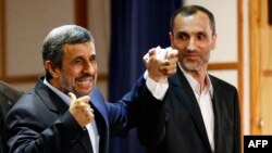 Former Iranian President Mahmud Ahmadinejad (left) stands with former Vice President Hamid Baghaei after registering at the Interior Ministry's election headquarters as candidates for the upcoming presidential election in Tehran on April 12.