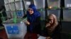Afghan election commission workers prepare to cut open the seals to a box containing ballot papers for an audit of the presidential runoff votes at a counting center in Kabul on July 17.