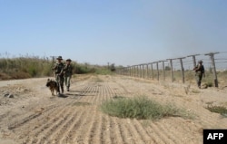 Tajik border guards patrol the Afghan border somewhere outside Panj.