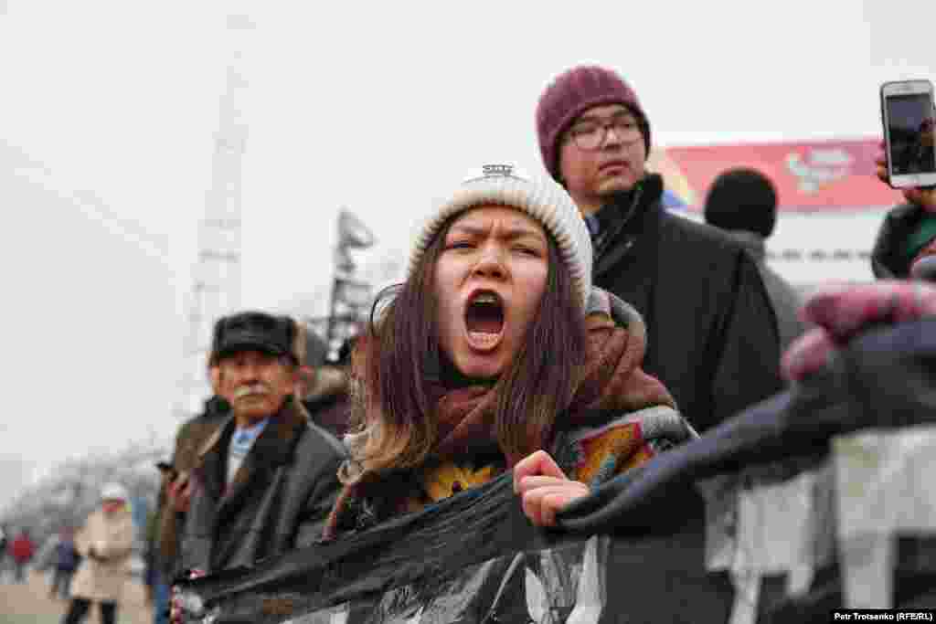 A young woman protests in Almaty. The rallies were called to mark Kazakhstan's Independence Day, as well as the anniversaries of the crackdowns in 1986 and 2011.