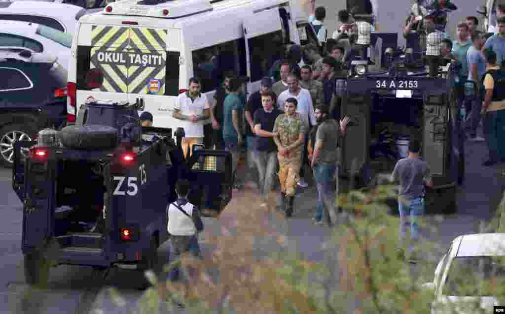 Turkish police arrest Turkish soldiers at Taksim Square in Istanbul. Fighting continued as the sun rose over Turkey, but the coup appears to have largely failed. President Erdogan said the events were "a gift from God" that would enable Turkey to "claim our military from the members of this gang."