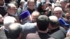 Armenia - Catholicos Garegin II hugs Archbishop Mikael Ajapahian during a standoff with security forces at the Echmiadzin headquarters of the Armenian Apostolic Church, June 27, 2025.