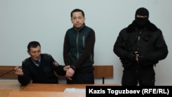 Aset Abishev (center) in court on November 30 